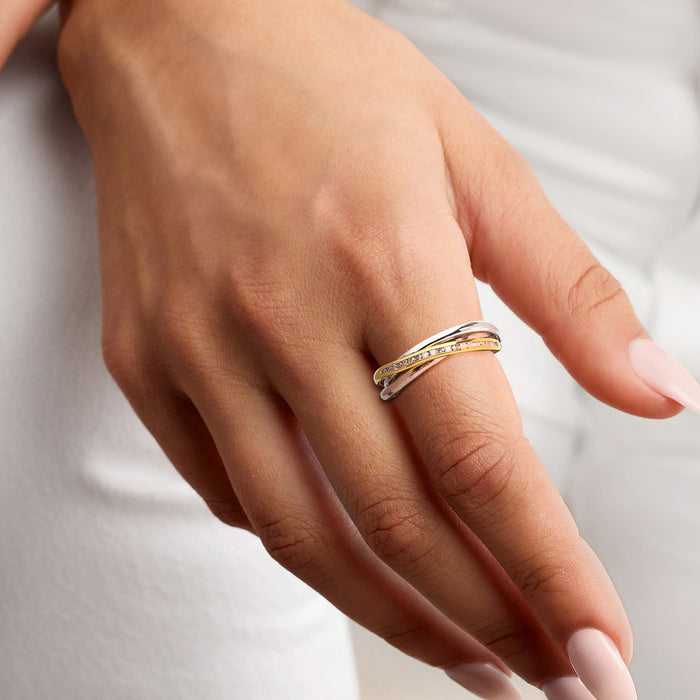 Tri-colored diamond band ring on finger with gold, rose, and white thin rows