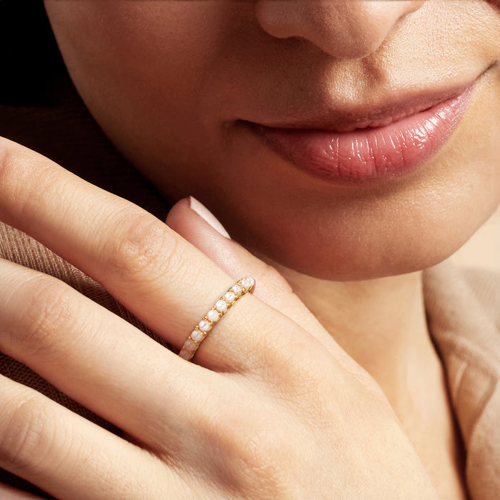 Gold over sterling ring with tiny white cultured pearls, worn on a finger