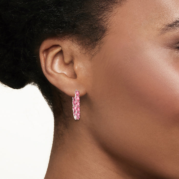 Pink topaz hoop earrings in sterling silver, shown on ear side view