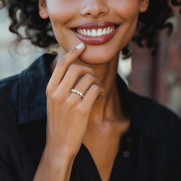 Woman's hand wearing a sterling silver diamond ring with five multi-shaped lab-grown stones