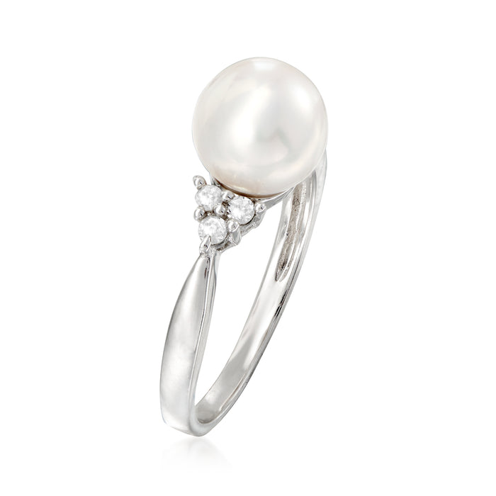 Sterling silver ring with single white pearl and diamond cluster side setting