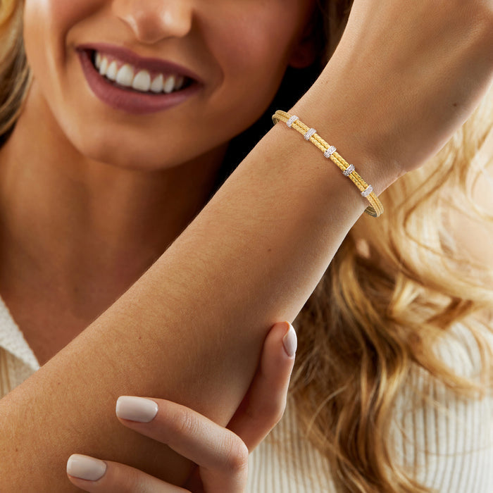 Two-row cuff bracelet with gold-tone mesh and silver CZ stations on wrist