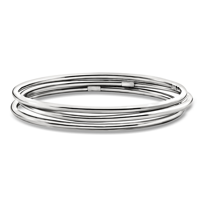 Three polished sterling silver bangle bracelets, stacked round hoops with smooth shine