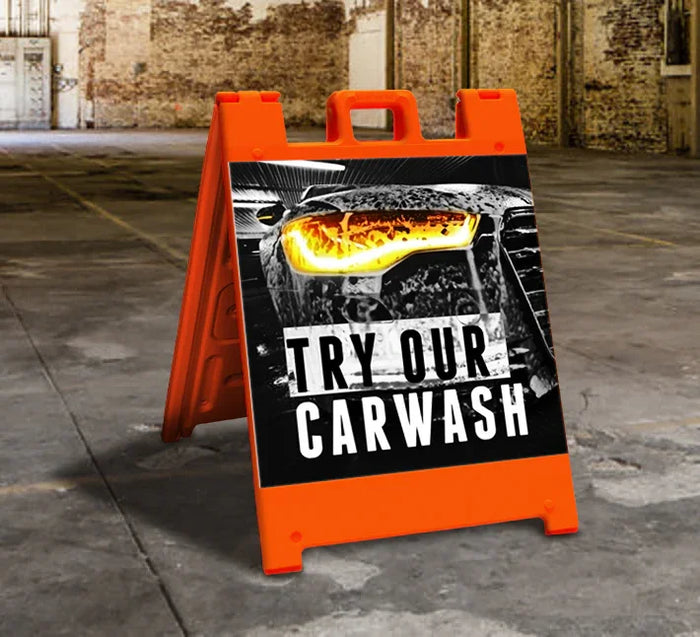 Bright orange A-frame sign advertising car wash with bold text and car image, ideal for storefront visibility.