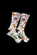 Knee-high socks with a festive, cannabis-themed pattern featuring gingerbread men and marijuana leaves, reading "Let's Get Baked".